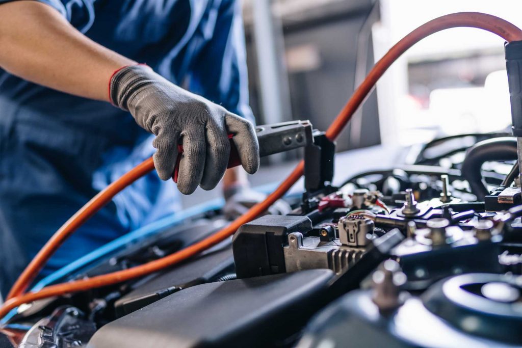 car electrical issues, close up of a mechanic working on a car